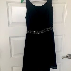 Black cocktail dress with beaded band and open back